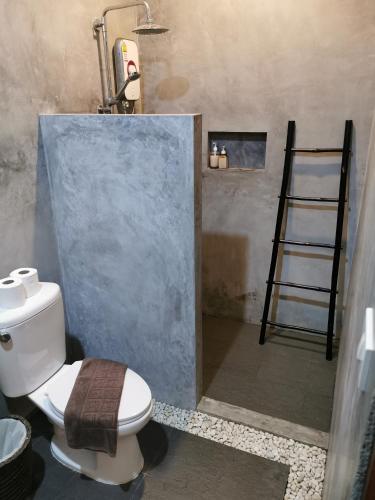 a bathroom with a toilet and a ladder in it at Baan Sukreep Resort in Chaweng Noi Beach