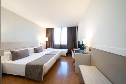 Säng eller sängar i ett rum på Catalonia Gran Hotel Verdi