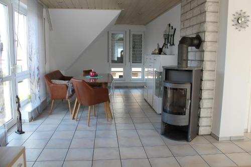 a living room with a fireplace and a table at FeWo Frankenstrasse in Rheine