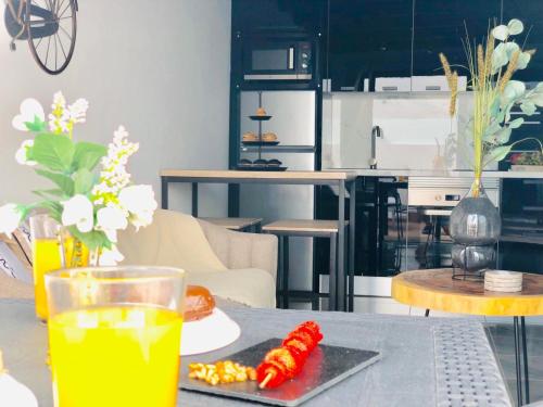 a table with a plate of food and a drink at Canaryislandshost l Nazaret Suites in Nazaret