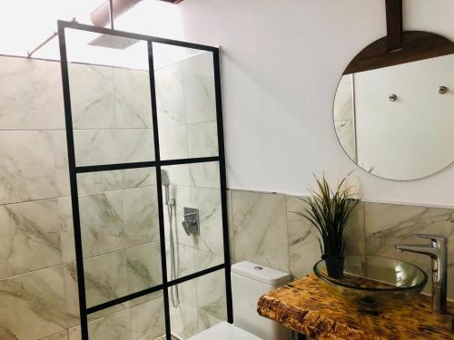 a bathroom with a shower and a sink and a mirror at Canaryislandshost l Nazaret Suites in Nazaret
