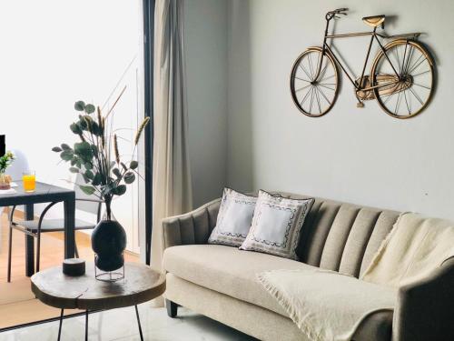 a living room with a couch and a bike on the wall at Canaryislandshost l Nazaret Suites in Nazaret
