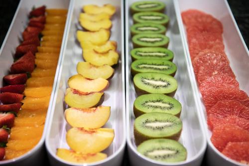 a tray of kiwis and other fruits and vegetables at Catalonia Gran Hotel Verdi in Sabadell