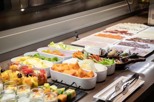 a buffet line with many different types of food at Catalonia Gran Hotel Verdi in Sabadell