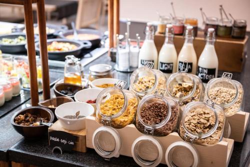 a buffet filled with food and bottles of milk at Catalonia Gran Hotel Verdi in Sabadell