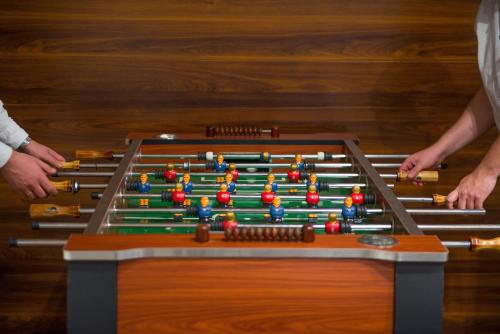 two people standing next to a giant snooker table at Hotel Kazimierzówka in Kazimierz Dolny