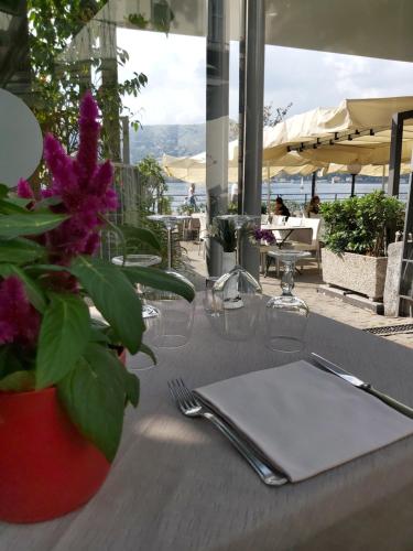 a table with a napkin on a table with a plant at Hotel Marco's in Como