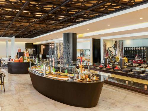 a restaurant with a buffet of food on display at Sofitel Abu Dhabi Corniche in Abu Dhabi