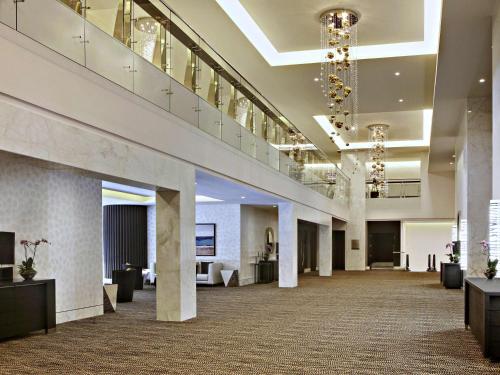 a large lobby with a staircase in a building at Sofitel Abu Dhabi Corniche in Abu Dhabi