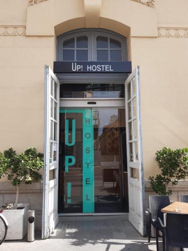 a door to a hotel with a sign on it at UP Hostel Valencia in Valencia