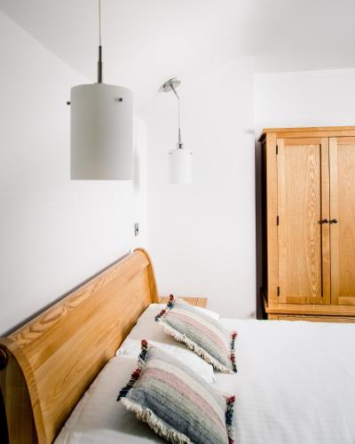 a bedroom with a bed with pillows on it at Gwesty'r Emlyn Hotel in Newcastle Emlyn