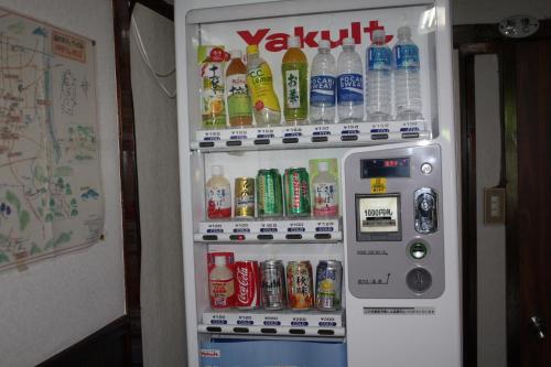 a refrigerator filled with lots of soda and drinks at Tamonkan in Tsuruoka