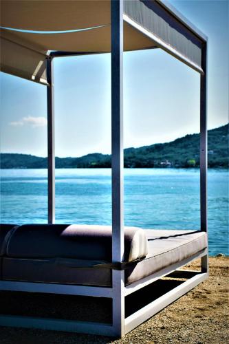 a bed with a view of a body of water at SENTIDO Apollo Palace in Mesongi
