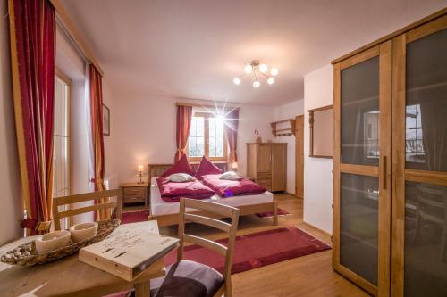 a living room with a bed and a table at Grillinghof in Kirchberg in Tirol
