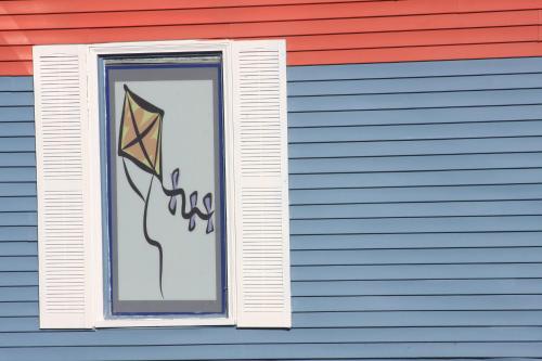 a window on a building with a kite in it at Heidi's Inn in Ilwaco