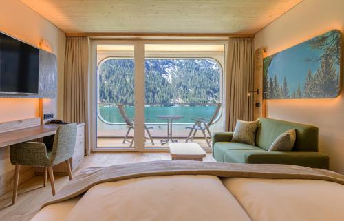 a room with a living room with a large window at haldensee - Naturerlebnis und Wellnesshotel in Nesselwängle