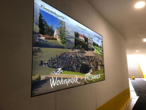 a large poster on a wall with a sign on it at Almtalhotel Appartements in Pettenbach in Pettenbach