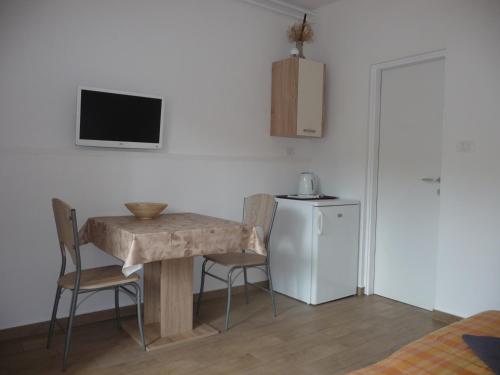 a living room with a table and a small refrigerator at Apartments Milka in Umag