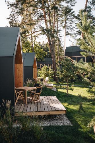 a wooden deck with a table and chairs in a yard at Luxury glamping Chocolate village in Maribor