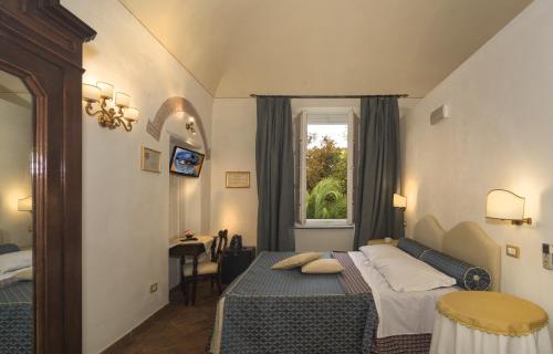 Postel nebo postele na pokoji v ubytování Il Mattino Ha L'Oro In Bocca