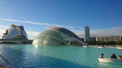 a group of people in a boat in front of a building at Beach Luxury Apartment in Valencia