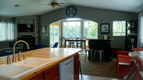 a kitchen with a sink and a living room at Alexander's Landing in Monticello