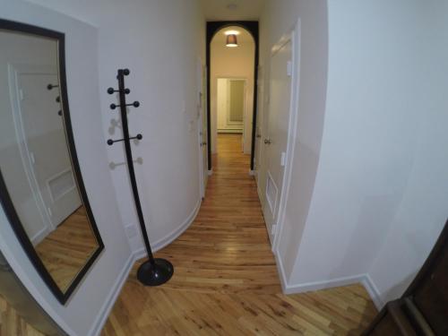 a hallway with a mirror and a wand at Historic 1869 Brownstone 15 min to NYC downtown in Jersey City