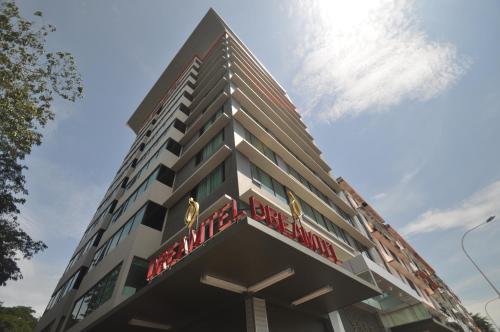 a tall building with a sign on it at Dreamtel Kota Kinabalu in Kota Kinabalu