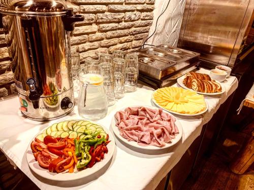 a table with four plates of food on it at Jánošíkova Valaška Hills Apartments in Terchová