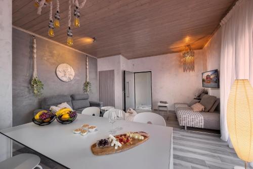 a living room with a white table and a couch at Macrame Suites in Tríkala