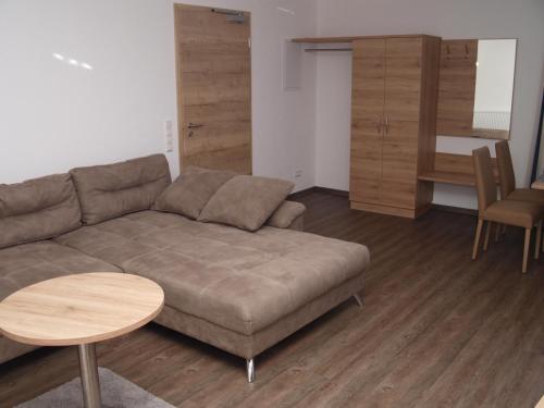 a living room with a couch and a table at Hotel Anker garni in Rastatt