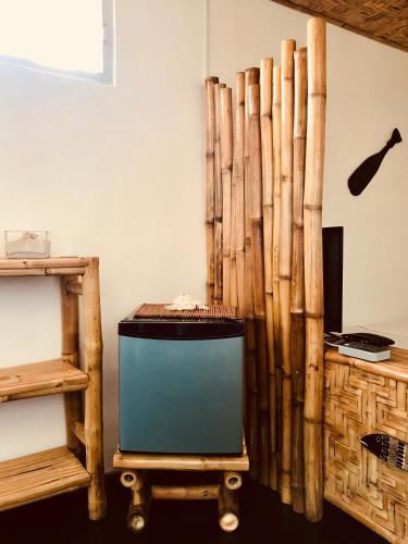 a room with a television and a wooden wall at Everyday Sunday Hotel & Cafe in Bantayan Island