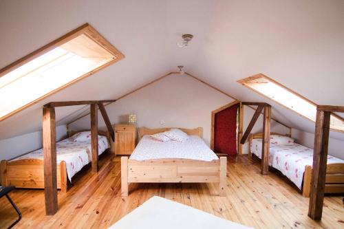 a bedroom with two beds and two skylights at Dandzenieki in Pāvilosta