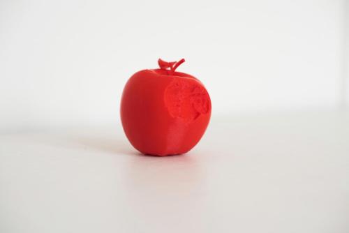 a red apple sitting on a white background at Hotel Mariënhage in Eindhoven