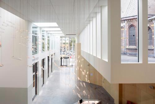 a hallway in a building with windows at Hotel Mariënhage in Eindhoven