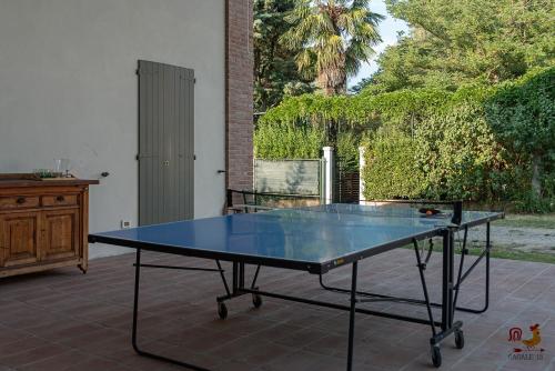 a ping pong table sitting on a patio at Casale13 in Faenza