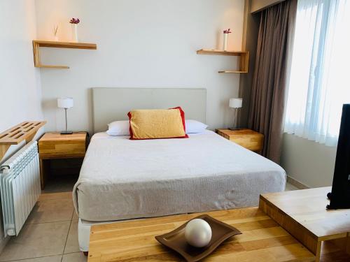 a small bedroom with a bed and a television at Miralejos in Ushuaia
