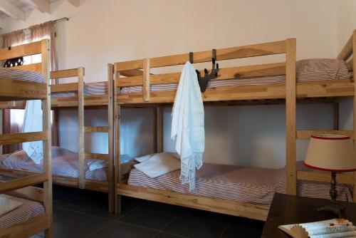 a room with three bunk beds in a room at Casale13 in Faenza