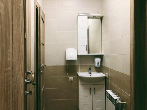 a small bathroom with a sink and a mirror at Annet in Kharkiv