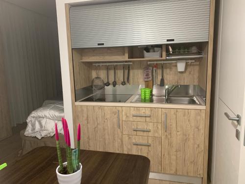a small kitchen with a sink and a table at B&B Vanessa in Alba Adriatica