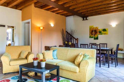 a living room with a couch and a table at Flowers Apartments in Desenzano del Garda