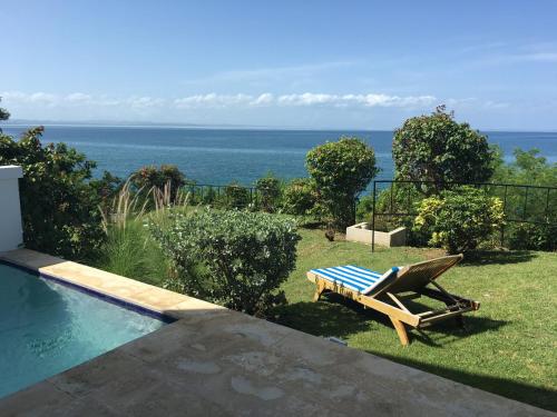 a pool with a lounge chair and a table next to it at THE VILLAS at THE HORNED DORSET PRIMAVERA in Rincon