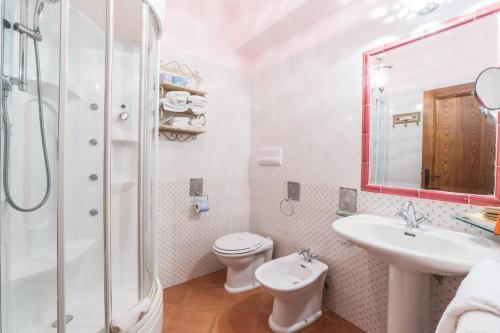 a bathroom with a toilet and a sink and a shower at Hotel Relais Pian delle Starze in Marina di Camerota