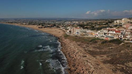 an aerial view of a beach with houses and the ocean at Covo dei Marinai in Cava dʼAliga