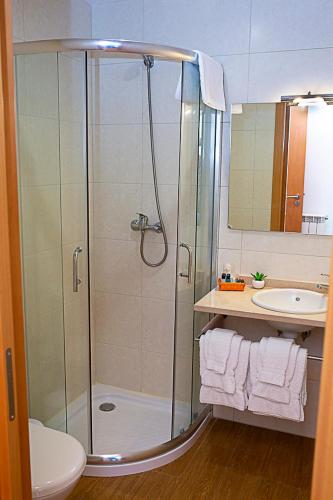 a bathroom with a shower and a sink at Regada House in Vieira do Minho