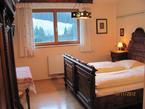 a bedroom with a large bed and a window at An der Mühle in Tux