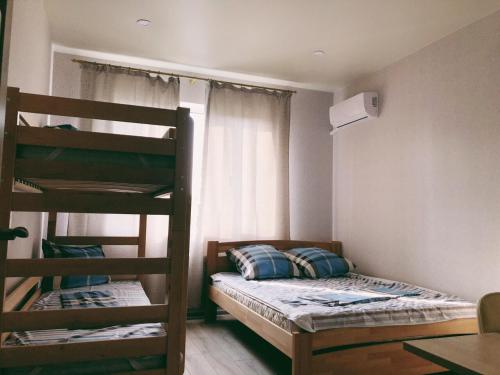 a bedroom with two bunk beds and a window at Annet in Kharkiv