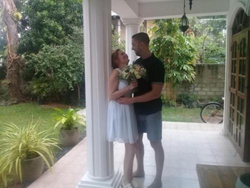 a man and a woman standing next to a column at Kuma Beach side Villa in Wadduwa