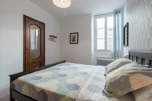 a bedroom with a bed with a quilt on it at Bright Apartment Old Town in Nice