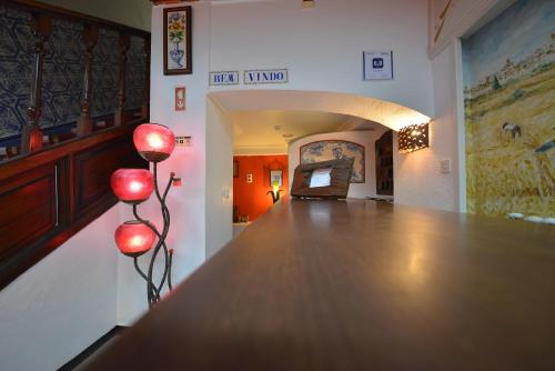 a dimly lit room with a red light at Hotel Bejense in Beja